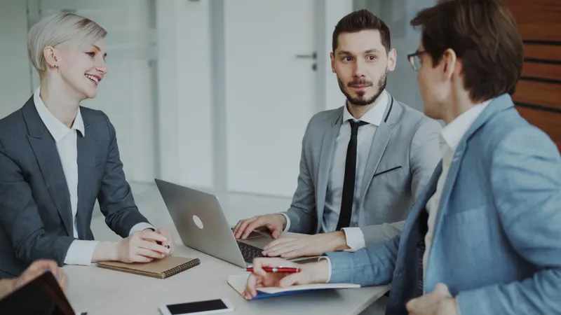 Small business team discussing which AI automation roles to hire for