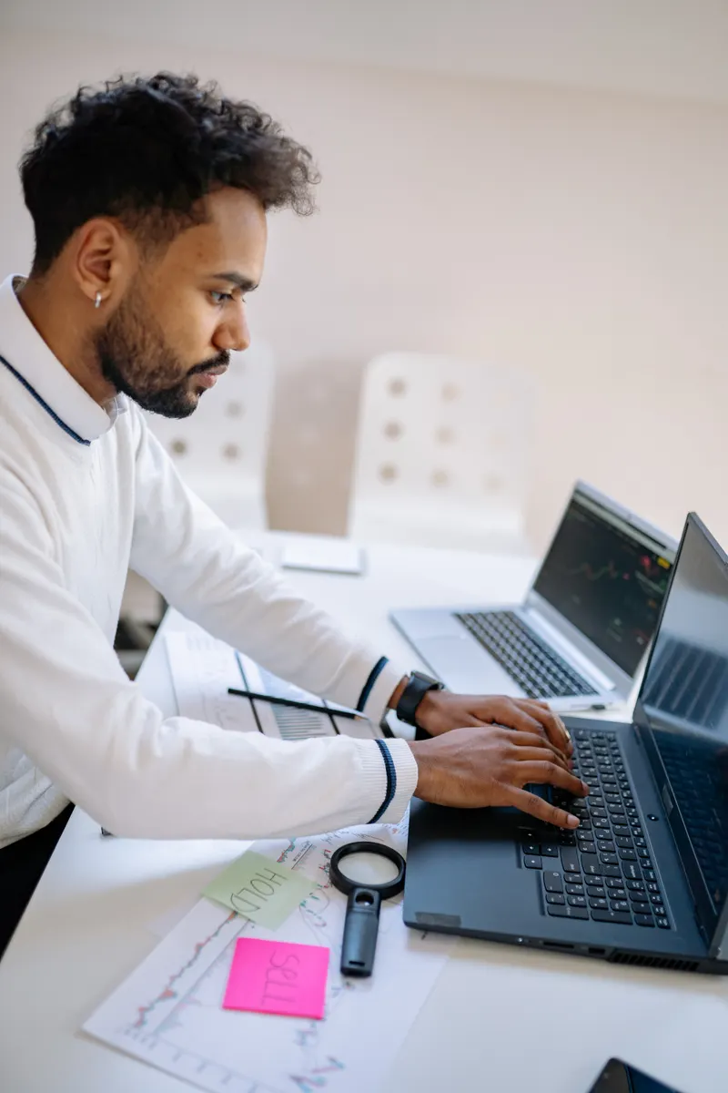 Business professional analysing data on a laptop, deciding between automation and AI solutions